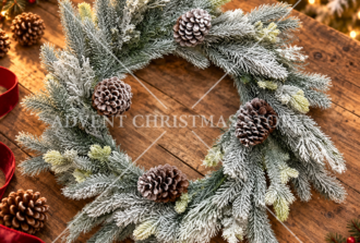 Snowy Christmas wreath with pinecones on a wooden table
